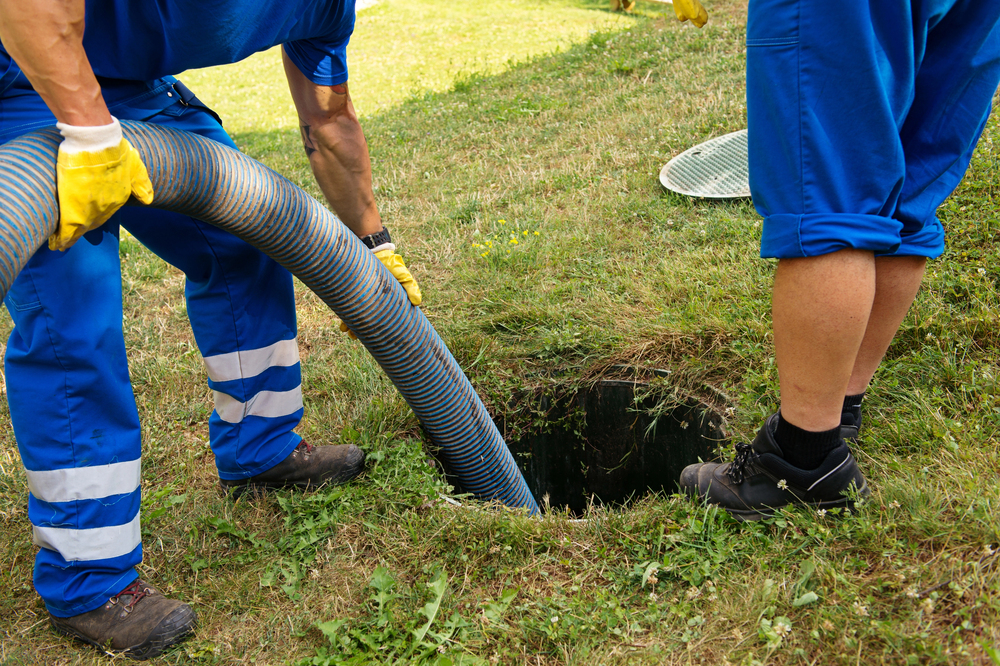 Vacuum truck hose at a septic tank