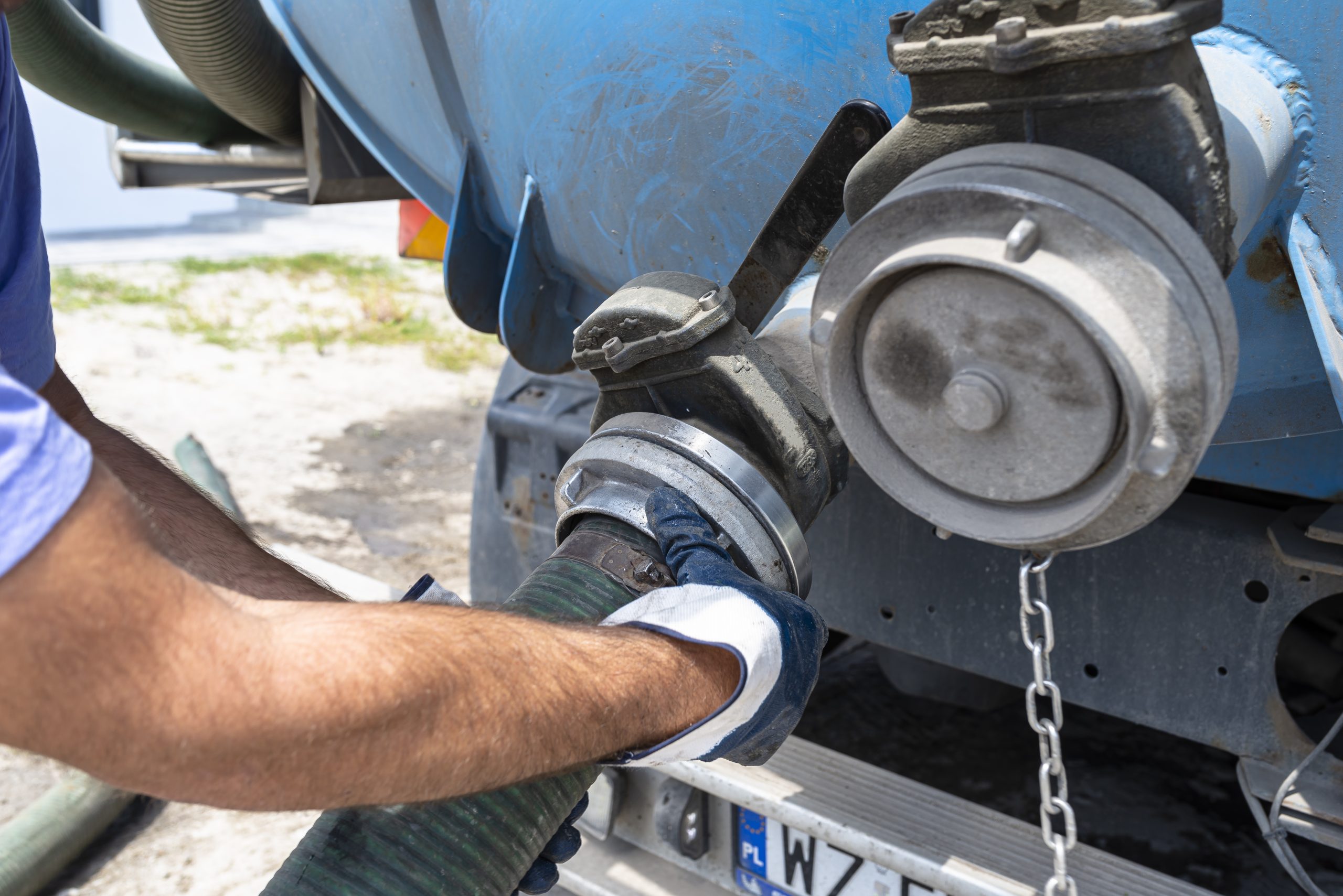 Hose being connected to a tanker truck